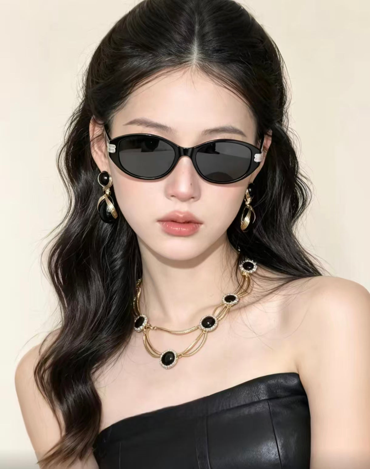 Adult woman wearing Matte Black cat-eye sunglasses, front portrait